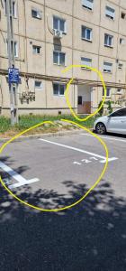 a yellow hose on a road in front of a building at ILIRIA's Home in Făgăraş