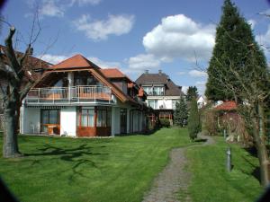 a large house with a green lawn in front of it at Strandhaus Hagnau in Hagnau