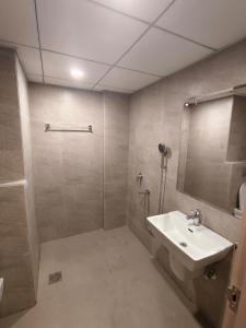 a bathroom with a sink and a shower with a mirror at Street dream homestay in Greater Noida