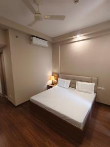 a bedroom with a large white bed with two pillows at Street dream homestay in Greater Noida