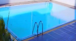 a large swimming pool with blue lights in it at Grand Plaza Hotel in Hat Yai