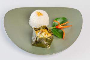 a plate of food with rice and carrots on it at Green Morodoc Garden Hotel in Siem Reap