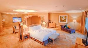 a bedroom with a large bed and a living room at Regency Hotel in Ma Yu