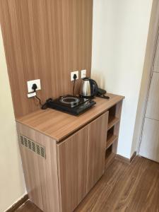 a wooden cabinet with a tea pot on top of it at Street dream homestay in Greater Noida