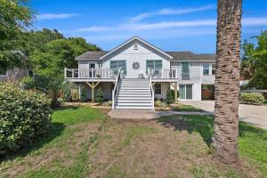 ein großes Haus mit einer Veranda und einem Baum in der Unterkunft AV4-22: 4 22nd Avenue in Isle of Palms