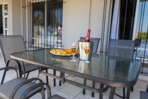 ein Tisch mit zwei Gläsern Wein und einem Teller mit Essen in der Unterkunft Seagull Apartment -2 Bedroom Apartment 408 by First Private Stays in Margate