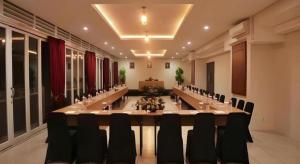 a large meeting room with a long table and chairs at Atrium Premiere Cilacap in Cilacap