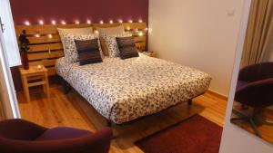 a bedroom with a large bed with lights on it at Apartment Jasmim in Lisbon