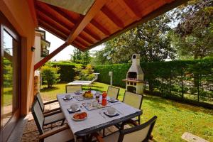 a table with food on it on a patio at Holiday Homes in Lignano 21665 in Lignano Sabbiadoro