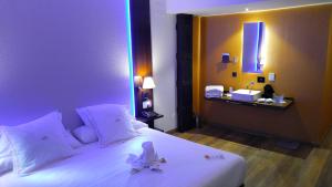 a bedroom with a white bed with a flower on it at MB Boutique Hotel - Adults Recommended in Nerja