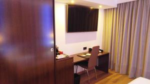a hotel room with a desk and a room at MB Boutique Hotel - Adults Recommended in Nerja