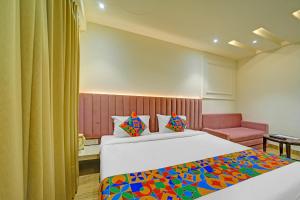 a bedroom with a bed with a colorful blanket at FabHotel Morya Regency - Bhopal railway station platform no 6 in Bhopal