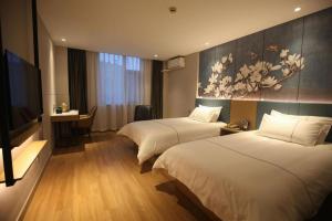 Postel nebo postele na pokoji v ubytování Magnotel Business Xuzhou Jinying Sudi Road Metro Station + 109 fotografií