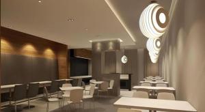 a dining room with tables and chairs and a chandelier at Jinjiang Inn Yantai Penglaige Zhonglou North Road in Penglai