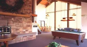 a large room with a pool table in a building at PowderWood in Kimball Junction