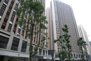 a group of trees in front of tall buildings at IU Hotel Chengdu High-Tech Zone Longhu Times Street in Xipu