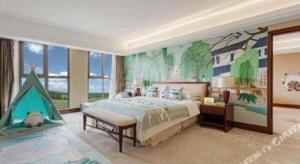 a bedroom with a large bed with a dinosaur mural at Four Points by Sheraton Kunshan in Kunshan +42 photos