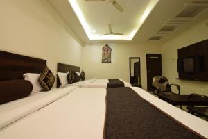 a bedroom with a large bed in a room at Hotel Krishna Palace in Udaipur +82 photos