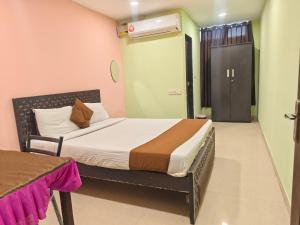 a bedroom with a bed in a room with a door at THE METRO INTERNATIONAL HOTEL in Hyderabad