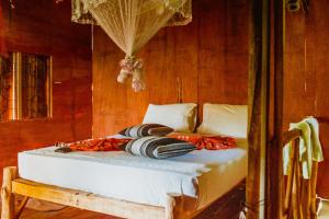 A bed or beds in a room at Sigiriya River Side Villa