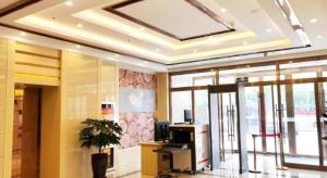 an office lobby with a desk and a large window at GreenTree Inn Urumqi Airport Tianyi International City in Ürümqi