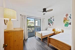 a bedroom with two beds and a balcony at MWV2063: 2063 Marsh Walk Villa in Seabrook Island +36 photos