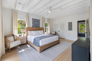 a bedroom with a bed and a chair and windows at SI3729: 3729 Seabrook Island Road in Seabrook Island +45 photos