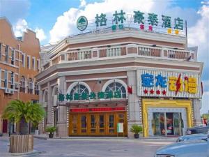 a building with chinese writing on the front of it at GreenTree Inn Taicang Baolong Square Hotel in Taicang
