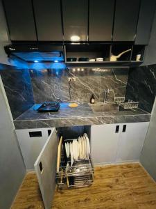 a kitchen with a sink and a counter top at Homey Hideout- Athena and Noah Units in Magalang