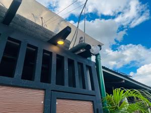 a building with a telescope on top of it at Homey Hideout- Athena and Noah Units in Magalang