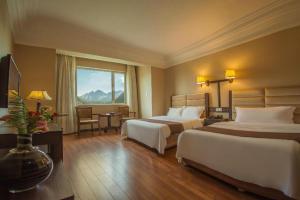 Postel nebo postele na pokoji v ubytování Anshan Camilla Business Hotel + 238 fotografií