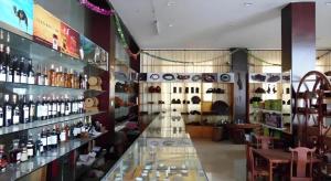 a store with a lot of bottles of wine at Xishuangbanna Hotel Managed by Xandria Hotel in Ban Nongkham