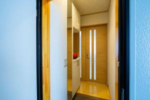 a hallway with a door leading into a room at バンビホーム青森中央 in Aomori