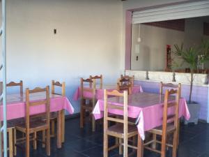 a dining room with a pink table and chairs at Hotel e Restaurante Residencial in Montes Claros
