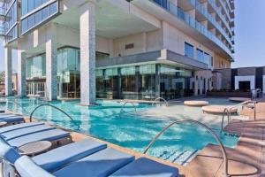 a swimming pool in front of a building at Palms place 51st floor & strip view in Las Vegas