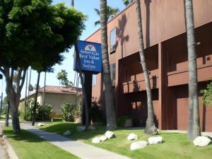 a sign in front of a building with rocks in front at Americas Best Value Inn & Suites Los Angeles Downtown SW in Los Angeles