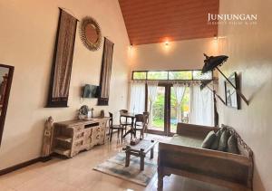 a living room with a couch and a table at Serenity Villa & Spa in Ubud