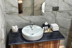 Un baño con un lavabo blanco y un espejo. en Xenious Opulent Hamirpur, en Hamīrpur 23 fotos más