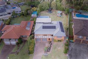 an aerial view of a house at Coastal Family Oasis with Pool, Outdoor Kitchen, Kids Play Area in Belmont