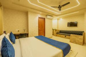 ein Schlafzimmer mit großem Bett und Fernseher in der Unterkunft Koramangala SeasonsSuites in Bangalore