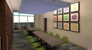 a cafeteria with wooden tables and green chairs at Holiday Inn Express and Suites Hannibal-Medical Center By IHG in Hannibal