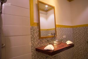 a bathroom with a bowl sink and a mirror at Zora Beach Inn Mathiveri in Mathiveri