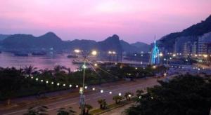 a view of a city with a river and mountains at Hai Long Hotel Cat Ba in Cat Ba