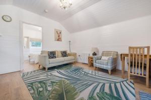 a living room with a couch and a chair at Ash Lodge in Ulverston