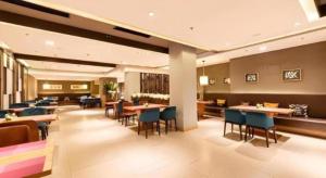a restaurant with tables and chairs in a room at Yitel Collection Shenyang Imperial Palace Zhongjie Metro Station in Shenyang