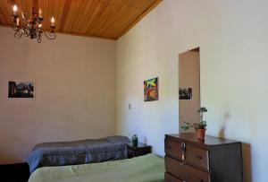 a bedroom with two beds and a dresser and a mirror at Casa Seibel in Quetzaltenango