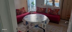 a living room with a table and a couch at Zaafrani mohamed in El Jadida
