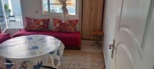 a room with a bed and a table and a window at Zaafrani mohamed in El Jadida