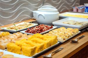 a buffet of different types of food on a table at Hotel Bahia do Sol in Salvador