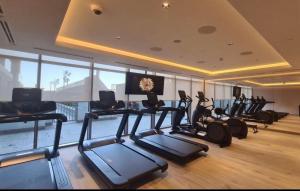 a gym with treadmills and exercise bikes in a room at Only female ladies only Private room shared bathroom of a residential tower vs pool view & downtown view & pv rooftop parking minimum staying of 5 nights in Dubai